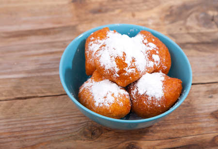 Traditional Dutch oliebollen on wooden backgroundの写真素材