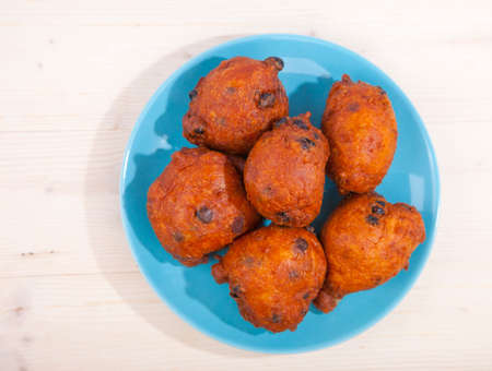 Traditional Dutch oliebollen on wooden backgroundの写真素材