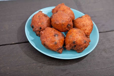 Traditional Dutch oliebollen on wooden backgroundの写真素材