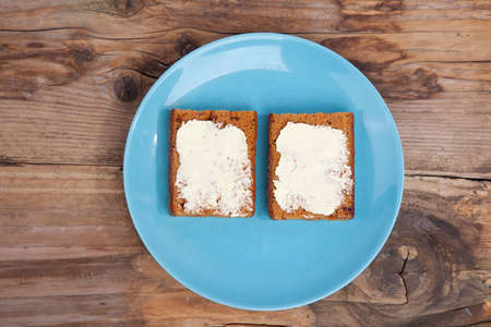 Traditional Dutch cake Ontbijtkoek with traditional butter on wooden backgroundの写真素材