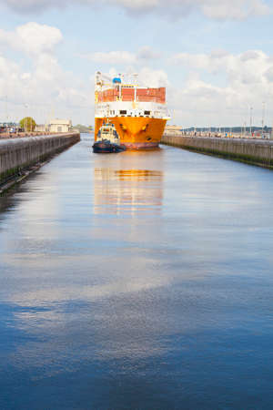 VELSEN, THE NETHERLANDS - May 31, 2011: Containership entering the sea lock at Velsen, The Netherlandsのeditorial素材