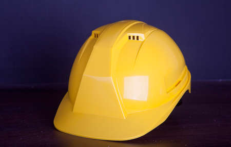 Yellow safety helmet on dark black backgroundの写真素材