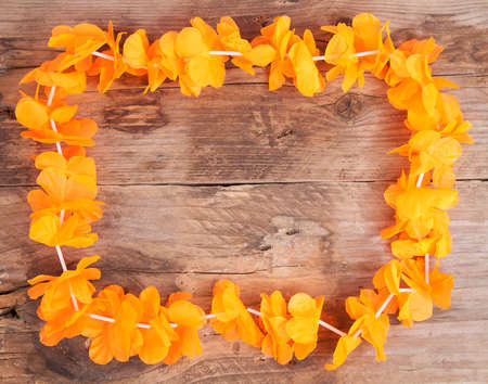 Dutch orange flower necklace on wooden backgroundの写真素材