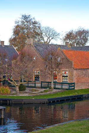 View at very old houses with canal in Enkhuizen, The Netherlandsの写真素材