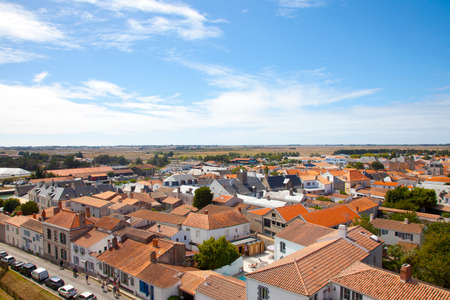 ILE DE NOIRMOUTIER, FRANCE - August 20, 2017: View at typical houses at island of Noirmoutier with red roofs and white wallsのeditorial素材