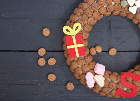 Wreath made of Dutch pepernoten on wooden backgroundの写真素材