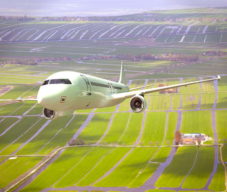 White 3D aircraft flying above Dutch landscaの写真素材