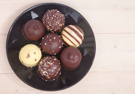 Typical Dutch chocolate treat with wipped cream inside on wooden background