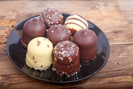 Typical Dutch chocolate treat with wipped cream inside on wooden backgroundの写真素材