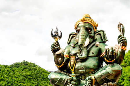 Green Ganesha Hindu God statue close up on natural backgroundの写真素材