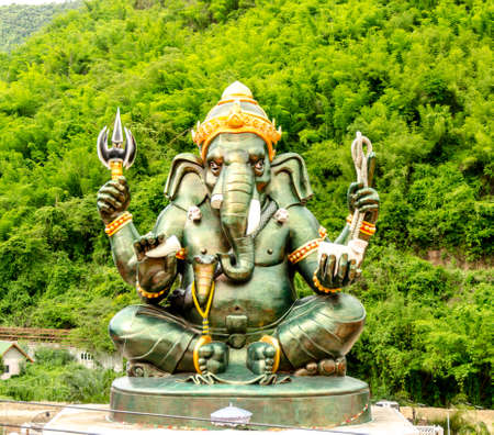 Green Ganesha Hindu God statue close up on natural backgroundの写真素材
