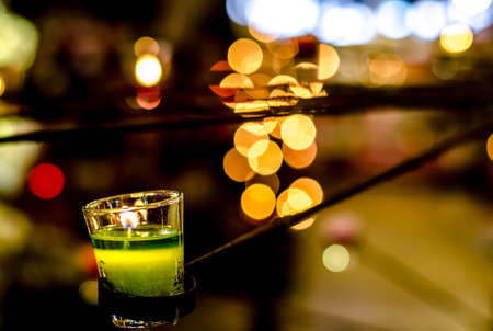 The Green candle on bokeh backgroundの写真素材