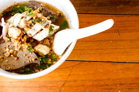 Spicy Noodle in a white bowl on wooden background. The favorite meal for lunch. Thailand food.の写真素材