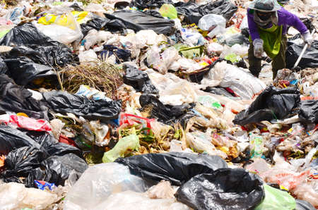 Employees and Scavengers are processing waste in Dump site at Ratchaburee City Thailand on May 6,...