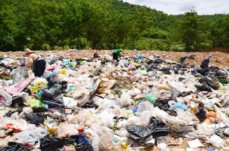 Employees and Scavengers are processing waste in Dump site at Ratchaburee City Thailand on May 6, 2012. People searching for refuse to recycle or resellのeditorial素材