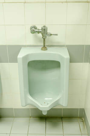 Closeup of the old blue urinals in menの写真素材