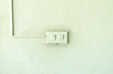 Old light switch on the green wallの写真素材