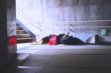 Vintage photo of homeless man rsleep in subway under the sunlightのeditorial素材