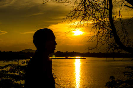 Silhouette the old man and sunset viewの写真素材