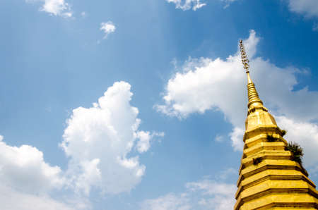 Golden pagoda on blue sky backgroundの写真素材
