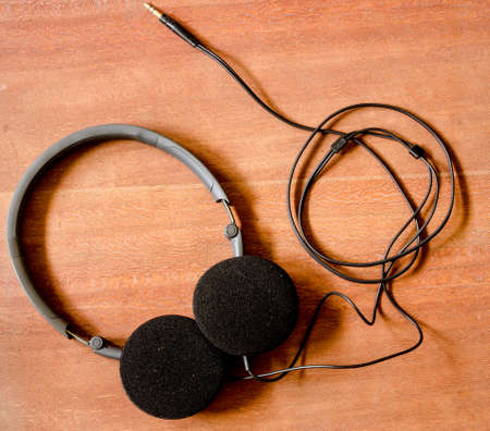 Black headphone on the old wood boardの写真素材