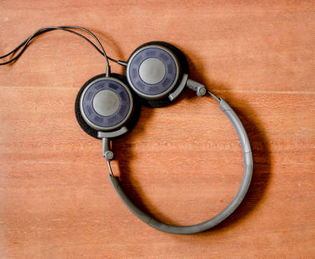 Black headphone on the old wood boardの写真素材