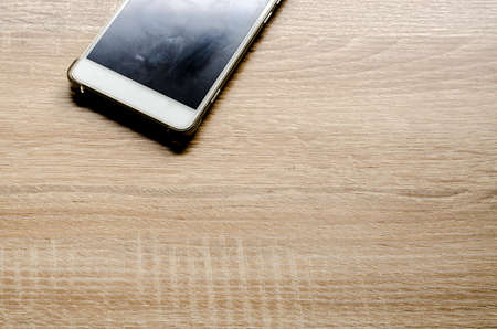 Smart phone on wooden table backgroundの写真素材