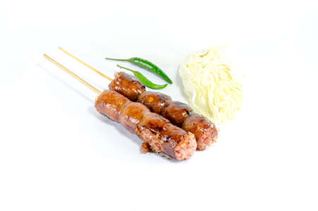 Thai Grilled Sausages on white background served with Cabbage and Chili Pepper. Thai Foodの写真素材