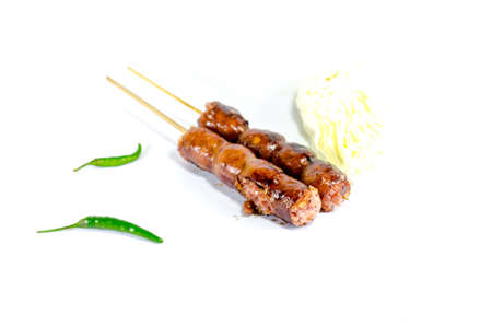 Thai Grilled Sausages on white background served with Cabbage and Chili Pepper. Thai Foodの写真素材
