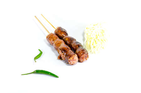 Thai Grilled Sausages on white background served with Cabbage and Chili Pepper. Thai Foodの写真素材