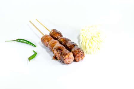Thai Grilled Sausages on white background served with Cabbage and Chili Pepper. Thai Foodの写真素材