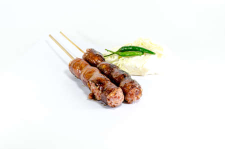 Thai Grilled Sausages on white background served with Cabbage and Chili Pepper. Thai Foodの写真素材
