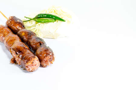 Thai Grilled Sausages on white background served with Cabbage and Chili Pepper. Thai Foodの写真素材
