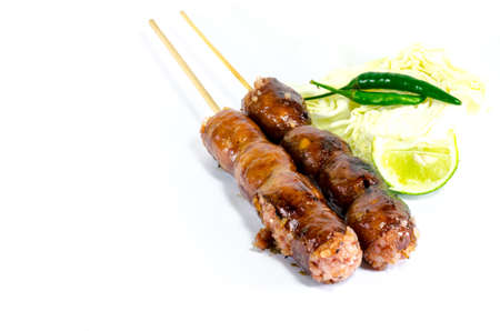 Thai Grilled Sausages on white background served with Cabbage and Chili Pepper. Thai Foodの写真素材