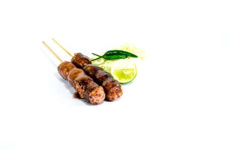 Thai Grilled Sausages on white background served with Cabbage and Chili Pepper. Thai Foodの写真素材