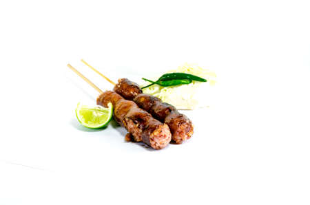 Thai Grilled Sausages on white background served with Cabbage and Chili Pepper. Thai Foodの写真素材