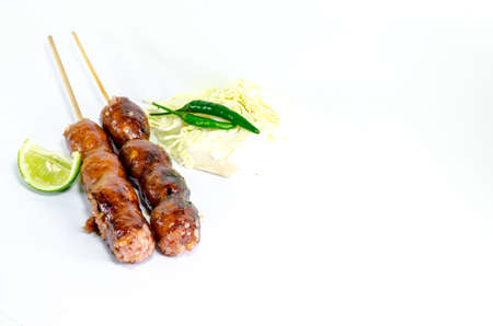 Thai Grilled Sausages on white background served with Cabbage and Chili Pepper. Thai Foodの写真素材