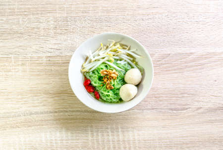 Thai Noodle with meat ball and crispy pork skin on wooden background. Thai Foodの写真素材