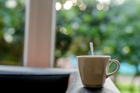 atmosphere around office blur background with bokeh and cup of coffee in the morning