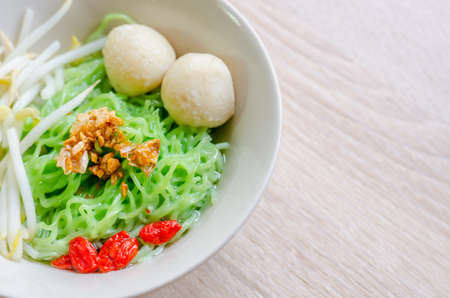Thai Noodle with fish ball and crispy pork skin on wooden background. Thai Foodの写真素材