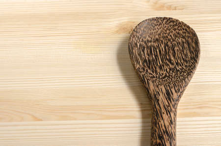Serving spoons on wooden surfaceの写真素材
