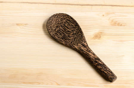 Serving spoons on wooden surfaceの写真素材