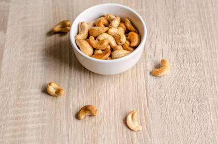 Close up cashew nuts on wooden backgroundの写真素材