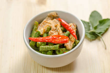Spicy stir fried pork with red curry paste and Yard Long bean, Thai food menuの写真素材