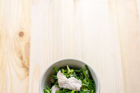 Stir Fried Pork with Chinese Chives Flower and Garlic on wooden backgroundの写真素材