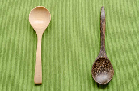 Wooden kitchen spoons on green tableclothの写真素材