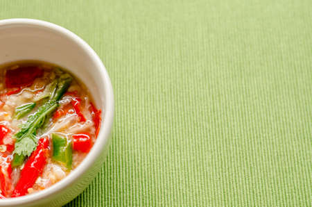 Thai spicy seafood dipping sauce on green  backgroundの写真素材