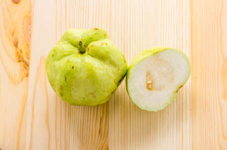 The tropical fruit high vitamin c, fresh guavas on wood backgroundの写真素材