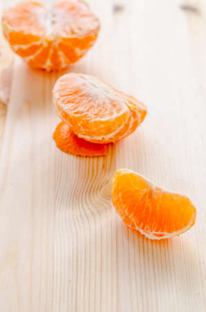 piece of fresh orange on a wooden backgroundの写真素材