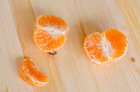 piece of fresh orange on a wooden backgroundの写真素材
